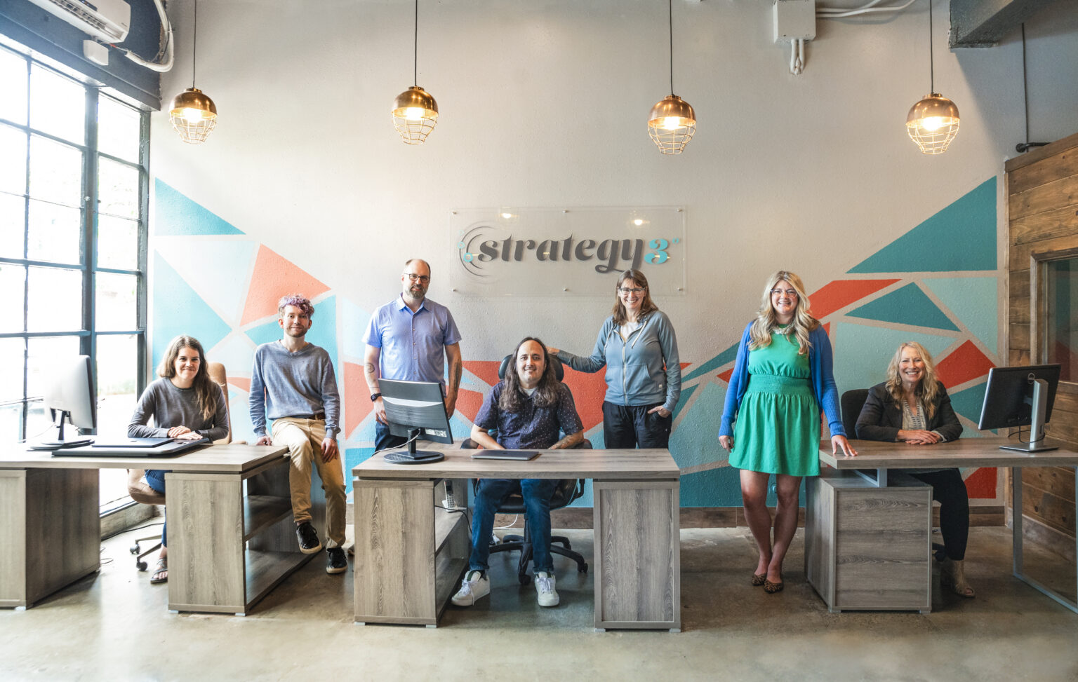 The Strategy 3 team at their desks in the Tacoma office